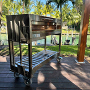 Tagwood BBQ Freestanding Argentine Wood Fire & Charcoal Gaucho Grill - BBQ18SS stainless steel with wheels, brasero firebox, and shelf.