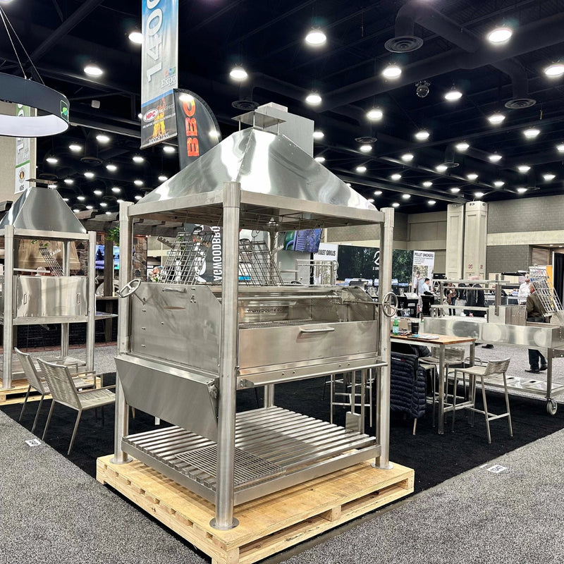 Tagwood BBQ XL Argentine Santa Maria Wood Fire & Charcoal Gaucho Grill in stainless steel with height-adjustable grates and firebrick interior.