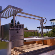 Tagwood BBQ XL Freestanding Argentine Santa Maria Grill in stainless steel with adjustable grates and gaucho-style brasero firebox.