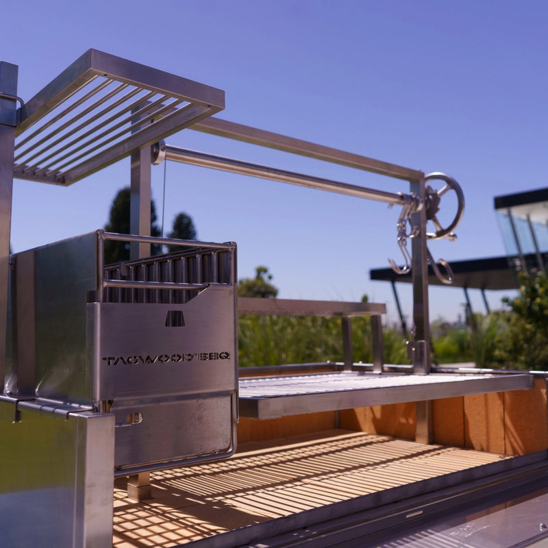 Tagwood BBQ XL Freestanding Argentine Santa Maria Grill in stainless steel with adjustable grates and gaucho-style brasero firebox.
