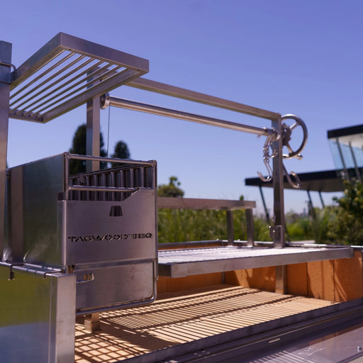 Tagwood BBQ XL Freestanding Argentine Santa Maria Grill in stainless steel with adjustable grates and gaucho-style brasero firebox.