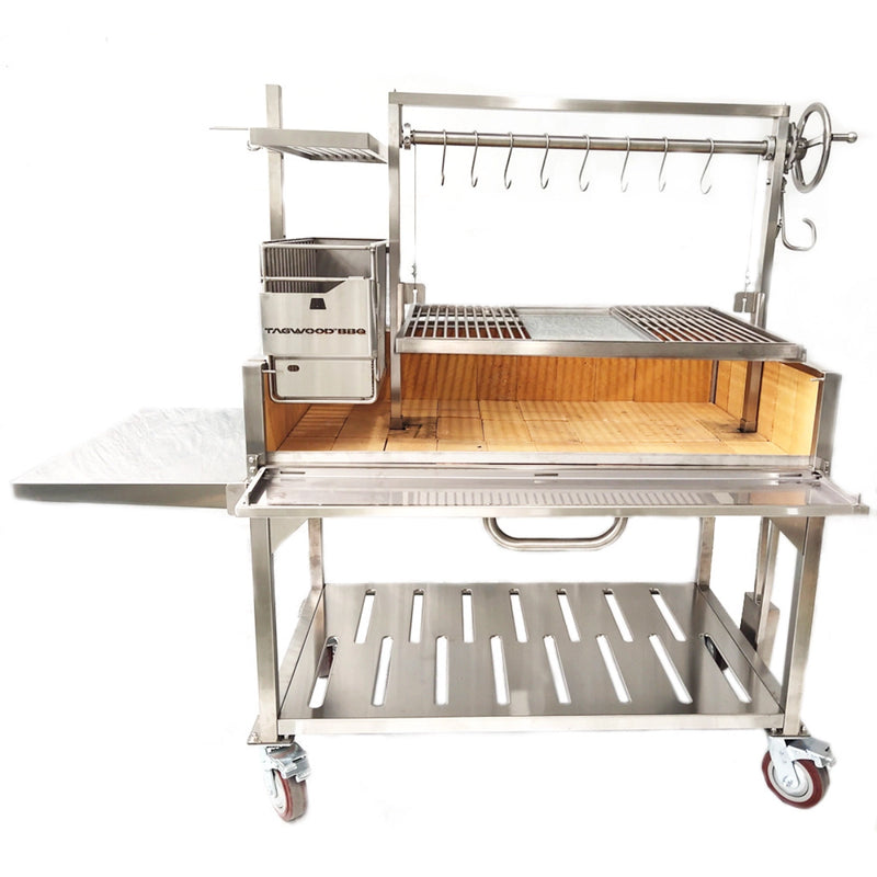 Tagwood BBQ XL Freestanding Argentine Santa Maria Grill with 304 stainless steel, height-adjustable grates, and a peaked roof on caster wheels.