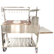 Tagwood BBQ XL Freestanding Argentine Santa Maria grill in stainless steel with height-adjustable grates, side shelf, and firebox on wheels.