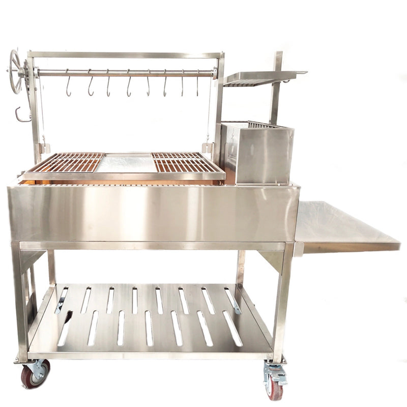 Tagwood BBQ XL Freestanding Argentine Santa Maria grill in stainless steel with height-adjustable grates, side shelf, and firebox on wheels.