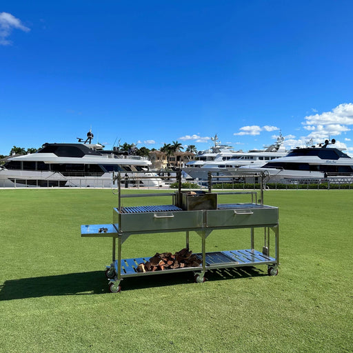 Tagwood BBQ XL Freestanding Argentine Santa Maria grill in stainless steel with double cooking space and gaucho firebox on wheels.