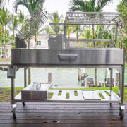 Tagwood BBQ XL Freestanding Argentine Santa Maria grill in stainless steel with height-adjustable grates and large cooking space on wheels.