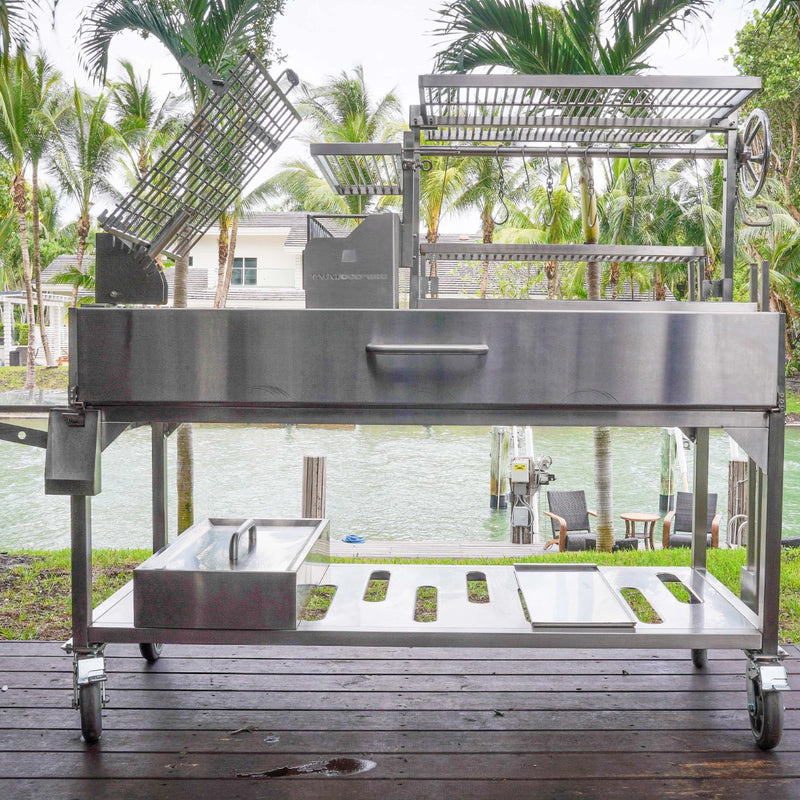 Tagwood BBQ XL Freestanding Argentine Santa Maria grill in stainless steel with height-adjustable grates and large cooking space on wheels.