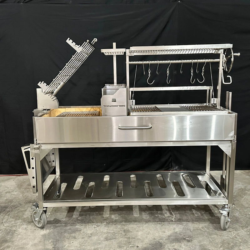 Tagwood BBQ XL Freestanding Argentine Santa Maria stainless steel grill with height-adjustable grates, brasero firebox, and hooks on wheels.