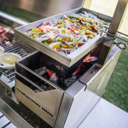 Tagwood BBQ Height Adjustable Griddle BBQ54SS stainless steel grilling surface with adjustable height over Santa Maria-style grill.