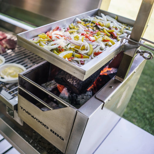 Tagwood BBQ Height Adjustable Griddle BBQ54SS stainless steel grilling surface with adjustable height over Santa Maria-style grill.