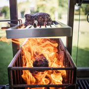 Tagwood BBQ Height Adjustable Secondary Grate BBQ55SS in stainless steel with adjustable height and expanded cooking surface on grill.