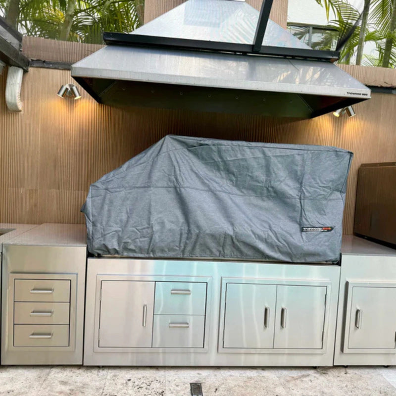 Tagwood BBQ BBQ28SS Cover in gray vinyl with adjustable drawstring, vent windows, and velvet liner protecting a built-in grill.