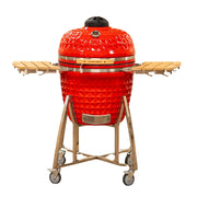 Red ceramic grill with wooden grilling surface on a white background