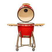 Red ceramic barbecue grill with wooden lid and stand on a white background