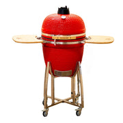 Red ceramic barbecue grill with wooden accents on a white background