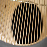 Close-up of a metallic grill with a dark center