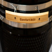 Wooden handle with 'Comfort Bilt' branding on a grill