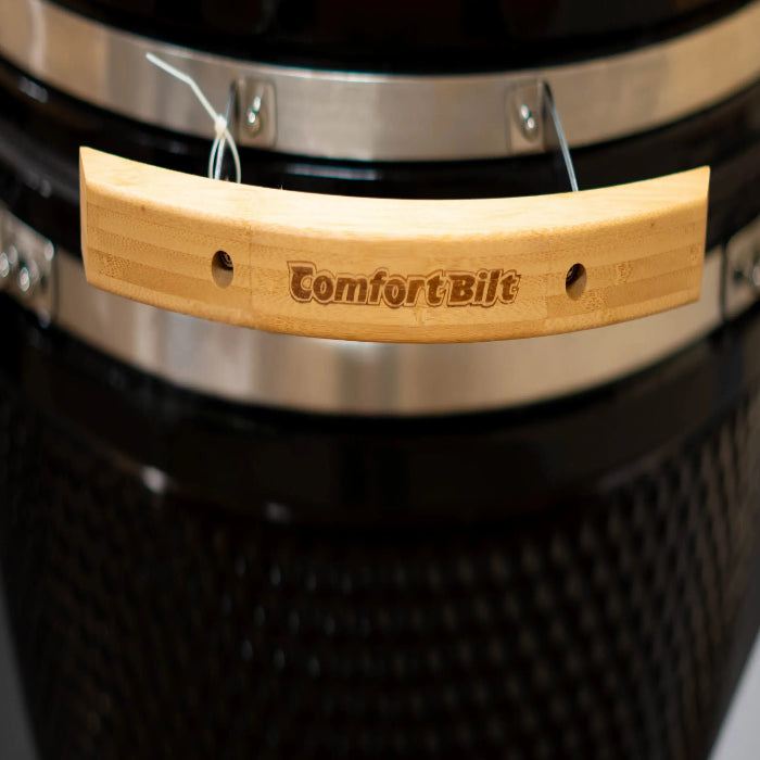 Wooden handle with 'Comfort Bilt' branding on a grill