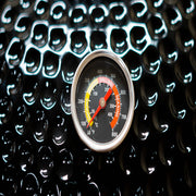 Thermometer gauge on a reflective black surface with a pattern