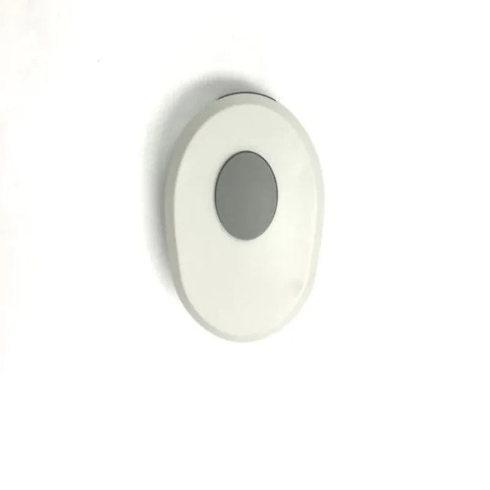 Round white light fixture on a white background