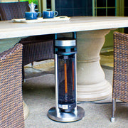 Outdoor patio heater under a table with chairs on a patio