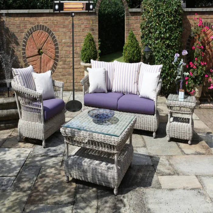 Outdoor patio set with wicker furniture on a stone patio