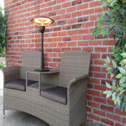 Outdoor patio set with table and chairs next to a brick wall