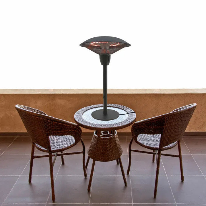 Outdoor patio heater with a round table and two wicker chairs on a tiled floor.