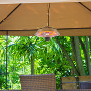Outdoor patio heater hanging from a canopy with greenery in the background