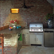 Outdoor kitchen with brick wall, grill, and countertop.