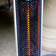 Portable electric space heater with glowing elements on a blurred background
