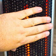 Hand resting on a textured surface with orange and black pattern