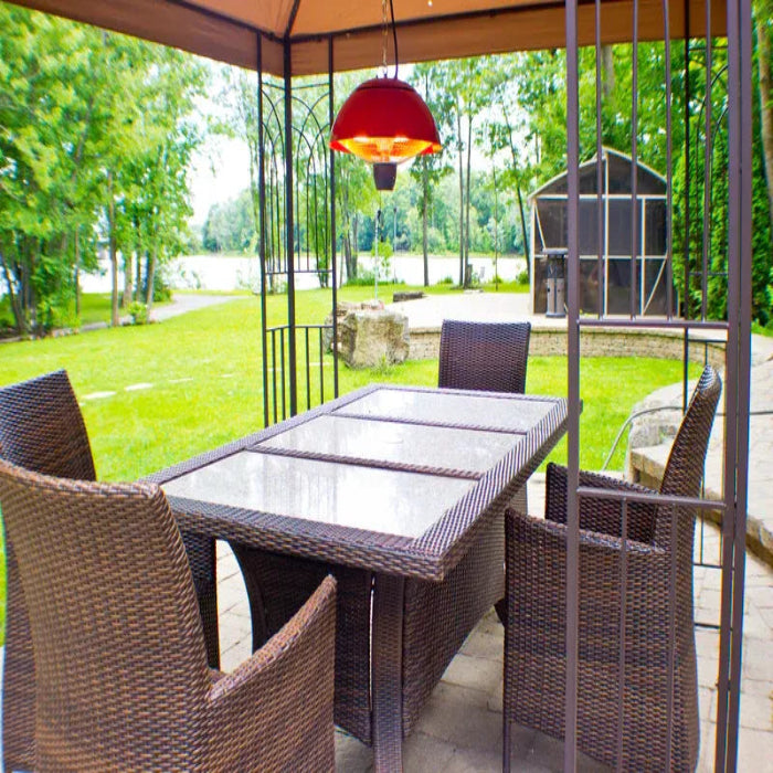 Outdoor patio set with table and chairs under a gazebo with a red hanging light.
