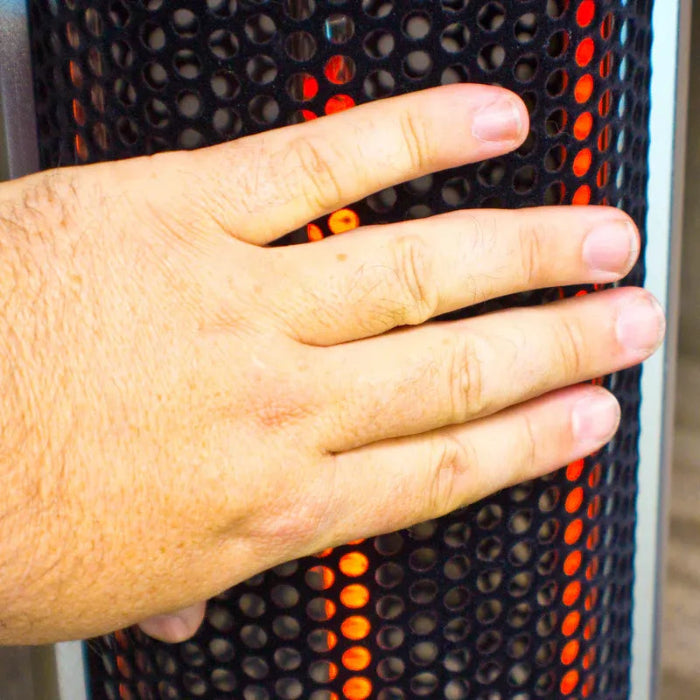 Hand resting on a textured surface with orange and black pattern