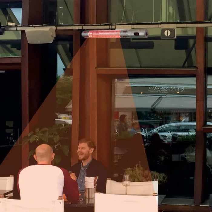 Two men sitting at a table outside a building with reflections on the glass.